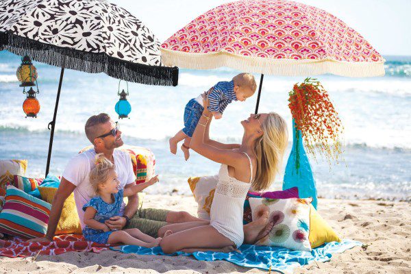 Beautiful photo of family enjoying the beach with fun accessories. Photo courtesy of www.Beachbrella.com) 